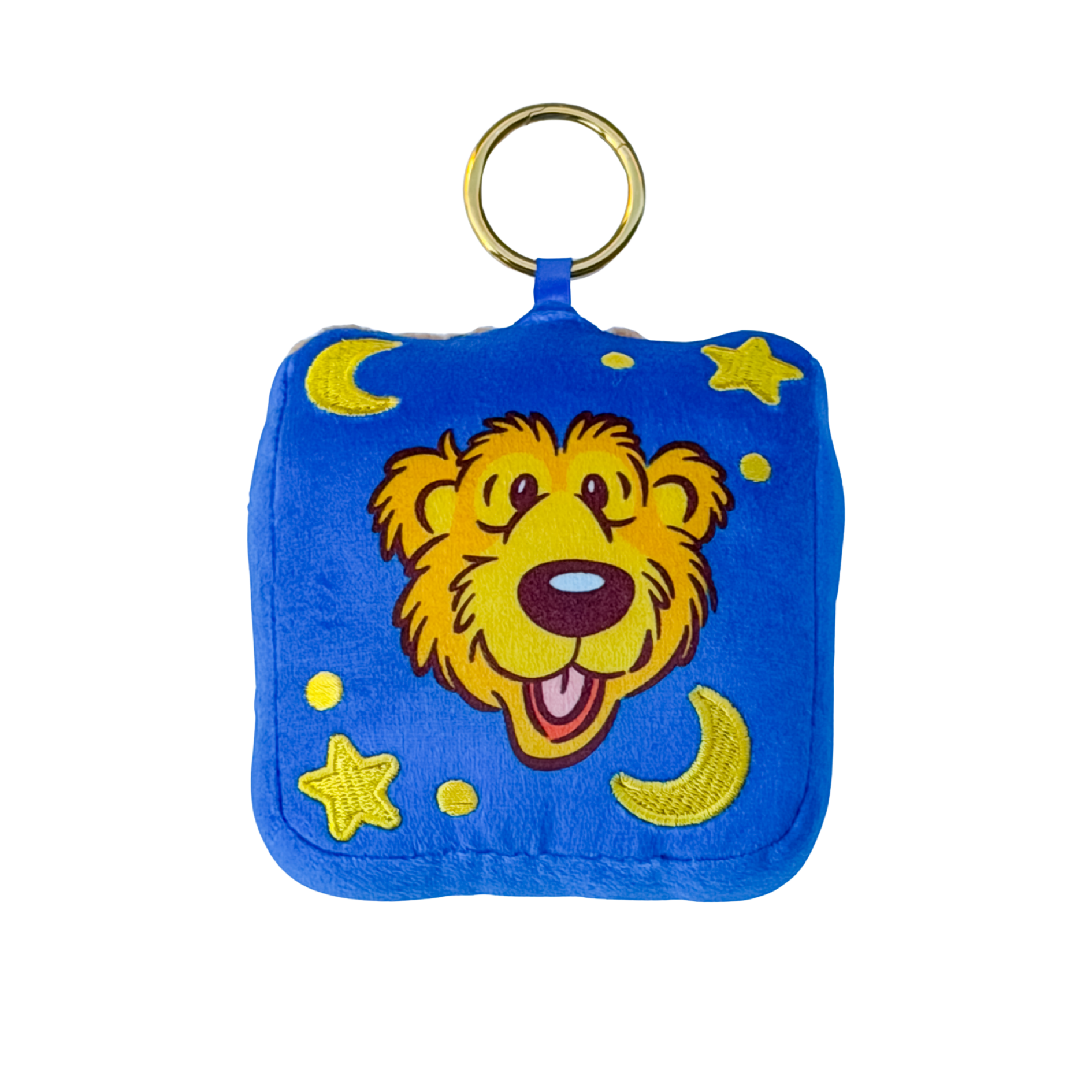 A square blue plush pouch or keychain bag with a gold metal ring at the top. The front features a cartoon bear face in yellow, brown, and pink, surrounded by yellow stars and crescent moons on a blue background.